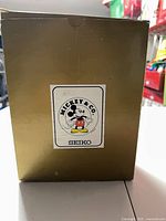 Front of gold box with Mickey & Co. Seiko label
