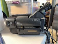 Left side of Sony Handycam Vision camcorder showing 64x digital zoom and Video8 XR markings