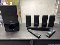 Complete system: subwoofer, five speakers, center speaker, two remotes