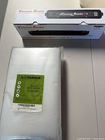 Sealer box beside sealed pack of 200 Avid Armor bags