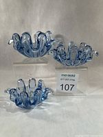 three aqua blue glass bowls side by side