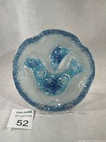 Full view of fused glass dish front displaying bird motif