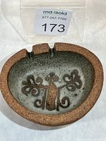 Top view showing full ashtray form, glazed interior design, twin rests