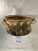 Front view of Robin Hopper stoneware casserole dish showing glaze and handles