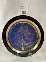Top view showing purple-blue glaze, gold bands and floral motif