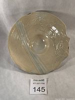 Front view of signed Sue Hopper porcelain dish showing carved decoration and overall form