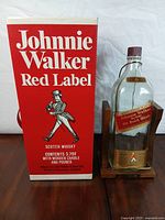 Bottle in cradle beside storage box