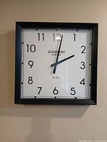Front view of square Glenmont wall clock on wall