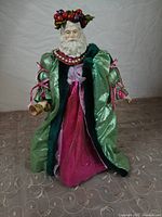 Front view of Father Christmas figurine showing costume and wreath