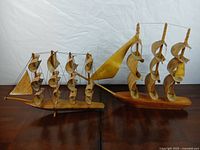 Both wooden ship models side by side showing overall design and size comparison