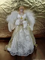 Front view of angel tree topper standing on table