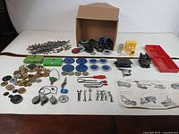 Overall layout of Meccano components with tools and instruction sheet displayed