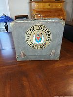 Front view closed showing crest, handle and latches