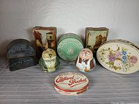 Group shot of all nine tins showing designs and relative sizes