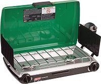 Stove open showing twin burners, grate, wind shields