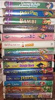 Stack of 14 Disney VHS tapes showing all titles on spines