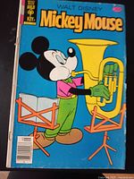 Cover of Walt Disney’s Mickey Mouse Gold Key comic showing blue background and Mickey playing a tuba