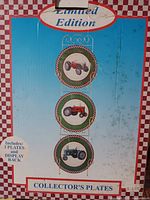 Box front showing Limited Edition collector's plates set with tractors and rack