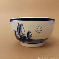 Side view of Delfts ceramic bowl showing sailboats and birds motif