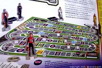 Close-up of racetrack game board and cardboard standees