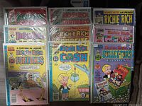 All nine bagged Richie Rich comics displayed upright in two rows