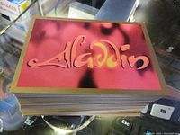 Stack of trading cards top card with Aladdin logo