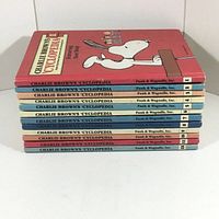 Stacked view of all volumes showing spines numbered 1-12