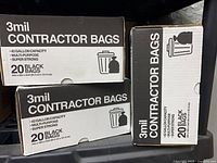 Three boxes of contractor bags stacked on shelving