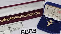 Bracelet in burgundy Camrose & Kross box with certificate, necklace box visible