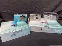 Both Canon cameras with their boxes and accessories