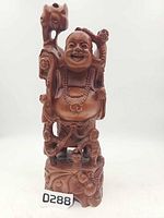 Full frontal view of entire carved wood Laughing Buddha statue