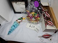 Full lot showing Radko ornaments (penguin, sleigh) and RAZ garland in box