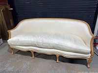 Front view of entire settee showing upholstery and wooden frame