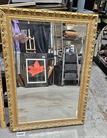Front view of mirror showing ornate gold frame and beveled glass