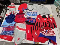 All hats, gloves and tee laid out on table