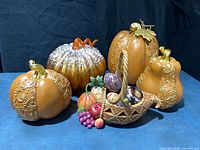 Group of five resin pumpkins/gourd and Jim Shore cornucopia with eggs