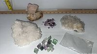 All five mineral specimens laid out with ruler for scale