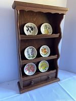 Front view of wall shelf with six plates displayed