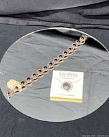 Full view of bracelet and boxed necklace on mirror