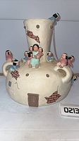 Full view of storyteller pottery vessel with attached figurines