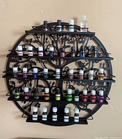 Front view of circular metal shelf filled with essential oil bottles