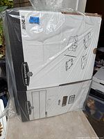 Package containing stack of Bankers Box file storage boxes with lids