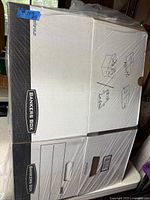 Flattened bundle of Bankers Box cartons wrapped in plastic