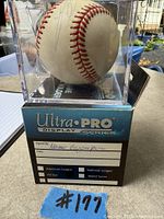 Front view of signed baseball in Ultra PRO display cube
