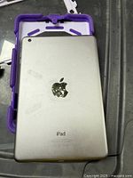 Rear view of silver Apple iPad in purple case