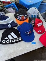 All items spread on table showing each cap and tuque