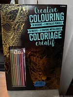 Front of boxed colouring set showing title, design count and pencils