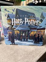 Front of slipcase showing title and village artwork