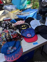 Table view showing nine assorted hats and caps