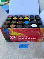 Open box showing 24 paint bottles